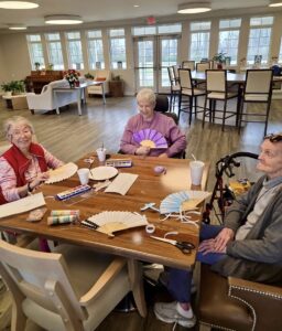 Local senior community brings 1900s elegance back with fan craft workshop