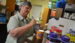 Deborah Ward sorts food items at Inside-Out Ministries. (CONTRIBUTED) 