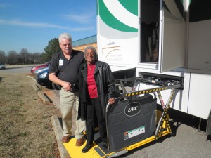 Tommy Murphy with the Big Green Bus greets Anna Gay, a member at Madison Senior Center. (PHOTO/VICKIE PARKER)