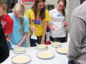 French Club members Krissy Decker, from left, Holly Romak and Kaley Bush cook crepes. (CONTRIBUTED)