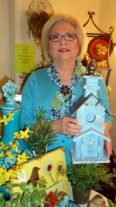 Cindi Sanderson, owner of CWS Interiors, holds a distressed birdhouse at her shop at 108 Main St. (RECORD PHOTO/GREGG PARKER)