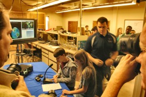 As photographers capture the session, Discovery students, seated, talk with an astronaut onboard the International Space Station. (CONTRIBUTED) 