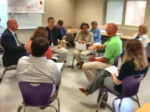 Jackie Walsh (center with notebook) participates in a 'fishbowl strategy' strategy' about quality questioning techniques with Dr. Brian Clayton, at left, and James Clemens teachers. (CONTRIBUTED) 