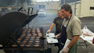 Volunteers grill hamburgers at a previous Community Awareness For Youth (CAFY) event. CAFY will be held this year on Aug. 17. (CONTRIBUTED)