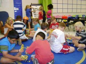Students divide into small groups for interactive time at the Expanded Day Learning Program at West Madison Elementary School. (CONTRIBUTED)