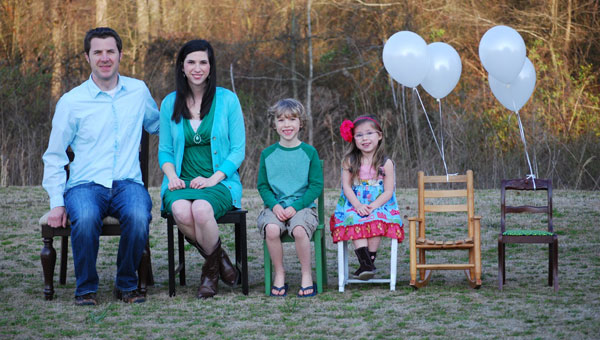 The Chapman family includes, from left, Brett, Amanda, Luke and Ansley Kate. Two empty chairs represent two children from China that they are in the process of adopting. (CONTRIBUTED) 