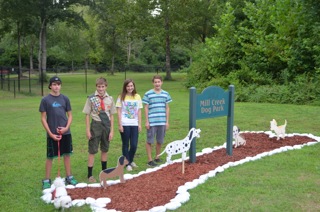 Jack Tamas, second from left, and his work crew inspect his garden and signs at Madison Dog Park. (CONTRIBUTED) 