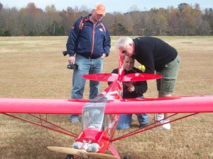 Jeremy Hartmann of Birmingham and Chris Woodward of Nashville look over Woodward's J-4 Tow plane during a NARCA meet. (CONTRIBUTED) 