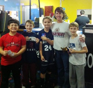 Joy Brindley, second from right, congratulates Jonathan Tatum, from left, Dylan Harbour, Max Vandeberg and Jordan Harper at the "Strike Out Cancer Bowl-a-Thon" for St. Jude Children's Research Hospital. (CONTRIBUTED) 