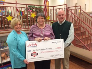 Alabama Education Association President Anita Gibson, at left, presents a $1,500 check to Madison Elementary School teacher Julie Skipper. Principal Dr. Timothy Scott coordinated the surprise presentation for Skipper. (CONTRIBUTED) 