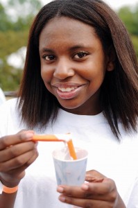 One of the YMCA's simple resolutions is to eat more fresh fruits and vegetables, like this woman snacking on a carrot. (CONTRIBUTED) 