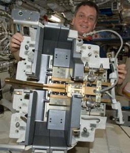 Astronaut T.J. Creamer examines a component of the International Space Station. (PHOTO/NASA)
