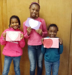 Mikala Calhoun, from left, Joy Robinson and Aysiah Young proudly show Valentines they made at West Madison. (CONTRIBUTED) 