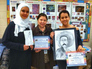Discovery students Iman Gadalla, at left, and Annika Gomez, at right, join art teacher Raquel Spiegel in showing their black history art awards. (CONTRIBUTED) 