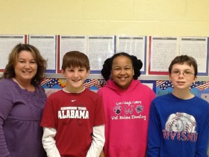 West Madison fifth-grade teacher Minnie Eichelkraut discusses Liberty's Legacy essays with Logan Hittle, from left, Chelsey Glaspie and Noah Fursterio. (CONTRIBUTED) 