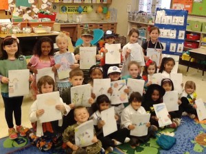 Kindergartners  at Mill Creek Elementary School proudly show their reports that answer "What do you want to do when you grow up?" (CONTRIBUTED) 