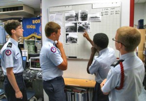 Richard Carr, third from left, points out a photograph of an aircraft in the Doolittle Raid to fellow students Nickolas Simmons, from left, Jonah Jenkins and Christian Weiss. (CONTRIBUTED) 