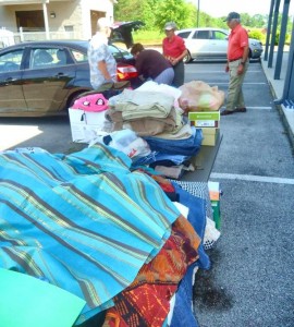 Individuals unload stacks of clothing, either new or in good condition, at 100 Plaza Blvd. in Madison on May 5. Limestone Countians who survived the April 28 tornadoes will receive the supplies. (RECORD PHOTO/GREGG PARKER)