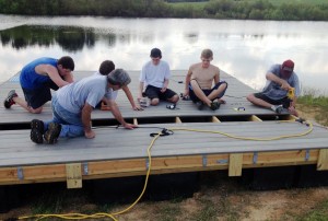 Colton Pearson, back left, and his crew work on the floating dock at Camp Hulaco for his service project to earn the Eagle Scout rank. (CONTRIBUTED) 