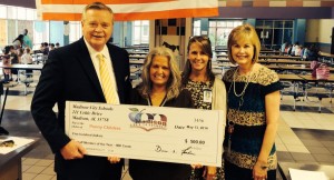 Penny Childers, second from left, receives her $500 check as Staff Member of the Year from superintendent Dr. Dee Fowler, from left, Mill Creek Principal Dr. Claudia Styles and coordinator of elementary instruction Judy Warmath. (CONTRIBUTED) 