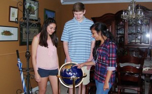 Amy Elizabeth Zari, from left, Allen King and Juhi Patel pinpoint Korea on the globe before leaving for Global Leadership Training with the Alabama-Korea Education Economic Partnership (A-KEEP). (CONTRIBUTED) 