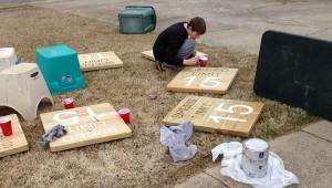 Tucker Pearson paints letters on signs for a local youth camp. He has earned the Eagle Scout rank. (CONTRIBUTED) 