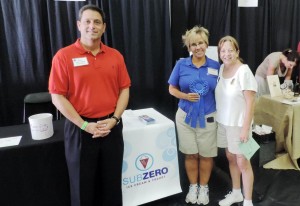 Madison Mayor Troy Trulock and chamber executive director Susie Massoti, at right, congratulate general manager Stacie Lewis with Sub Zero Ice Cream & Yogurt, first-place winner among booths at the Business Expo and Kids Day. (CONTRIBUTED) 
