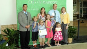 Madison Mayor Troy and Dana Trulock, far left and far right, congratulate "Madison Family of the Year" LeAnne Letize McGee and Benjamin McGee and their children Max, Zac, Alia and Zoe. (CONTRIBUTED) 