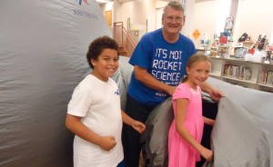 James Brelsford with Von Braun Astronomical Society leads Frankie Mack, at left, and Carley White into the portable planetarium during Space Week at Madison Elementary School. (RECORD PHOTO/GREGG PARKER) 