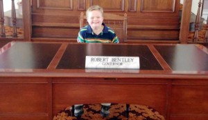 Samuel Evers, a second-grader at Columbia Elementary School, sat at Gov. Robert Bentley's desk at the proclamation signing for Alabama Down Syndrome Day on Oct. 1. (CONTRIBUTED)  