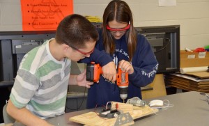 Members of Joule Bots, junior William Irrgang, at left, and freshman Anna Mathias work in the build phase of their robot's design process. (CONTRIBUTED)
