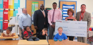 University Kia representatives Michael Lucente, from left, Arthur Seaton and Maurice Dobbins present $500 to Columbia Elementary School teacher Susan Sanford and Principal Jamie Hill. The schools received $4,500 from Kia. (CONTRIBUTED) 