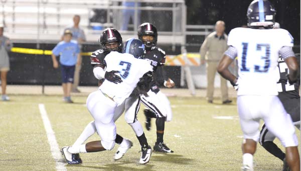 Gadsden City defensive back Dytereous Underwood tackles James Clemens running back Immanuel Wilder (3) in Region 4 action Friday. (Record Photo/Nick Sellers)