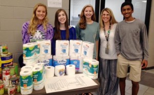 James Clemens High School students check the canned food and paper supplies that they have collected for their 2014 homecoming parade. (CONTRIBUTED) 
