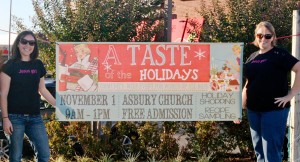 Rachel Cobb, at left, and Susie Averitt reveal the banner design for "A Taste of the Holiday" at Asbury united Methodist Church on Nov. 1. (CONTRIBUTED) 