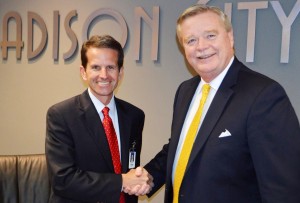 Madison Board of Education President Ray White, at left, congratulates Dr. Dee Fowler on his two-contract extension as superintendent of Madison City Schools. (CONTRIBUTED) 