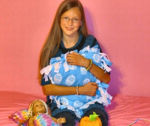 Alaina Burnham, 11, designs handmade, fleece-tied throw pillows and American Girl accessories with her business, "All Tied Up." (CONTRIBUTED) 