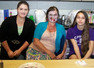 Discovery students Amber Blackmon, at left, and Faith Blankenship, at right, transformed James Clemens fashion design teacher Sherri Shamwell into a zombie for "Fashion Show of the Dead." (CONTRIBUTED) 
