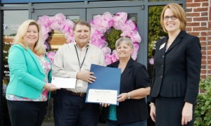 Lori Light with Crestwood Medical Center, at left, and Melissa Thompson with The Community Foundation, at right, present a grant to assist women and children to Inside-Out Ministries founders Larry and Deborah Ward. (CONTRIBUTED) 