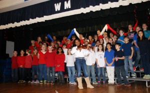 Violinist Emma Boyd, at center, performed "The Star-Spangled Banner" during "A Day of Honor" for military personnel at West Madison Elementary School. (CONTRIBUTED) 