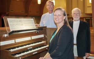 Lois Graff, director of music ministries at Messiah Lutheran Church, sits at the church's new pipe organ. Rev. Scott Peterson, at left, and Bob Gustafson joined other congregation members in selecting the organ. (CONTRIBUTED) 