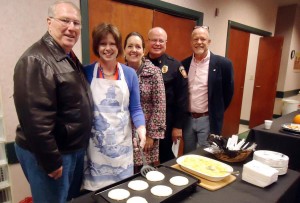 Sarah Sledge, second from left, prepares to flip pancakes at Grits and Gratitude, hosted by Madison Friends of the Library. City officials enjoying homemade breakfast dishes included councilman Mike Potter, from left, councilman Ronica Ondocsin, Madison Fire Chief Ralph Cobb and Council President Tommy Overcash. (RECORD PHOTO/GREGG PARKER) 
