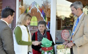 Dana Trulock, second from left, assists tour chairperson Marsha Willis in drawing winning prize tickets for guests at the Madison Christmas Historic Home Tour. Mayor Troy Trulock, at left, and Chris Crumbly, president of the Madison Station Historical Preservation Society, also participated. (RECORD PHOTO/NICK SELLERS)