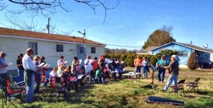 One Direction Community congregates conducted communion and worship after an outreach project to repair the roof, sheet rock, plumbing and appliances at a single mother's house trailer. (CONTRIBUTED) 