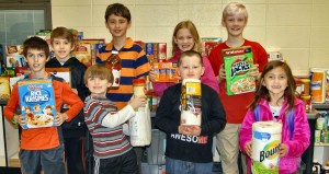 Columbia Elementary School students showing items donated to Inside-Out Ministries are Ronnie Humphrey (front row, from left), Connor Murphree, Matthew Adams and Emma Dickinson and Joshua Murphree (back row, from left), Tynan Gibson, Kaitlyn Hockey and Joshua Hockey. (CONTRIBUTED) 