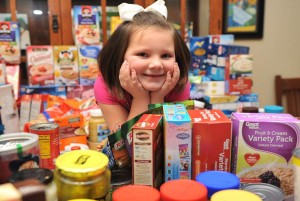 Kendall Preston collected all this food for Good Shepherd United Methodist Church's food pantry. (PHOTO / CRISTEN SMITH/FLASHLIGHTS & FIREFLIES PHOTOGRAPHY)