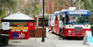 Yellow-and-black banners stating "Emergency Need" are displayed on LifeSouth bloodmobiles to encourage donors to stop and donate. LifeSouth uses the word 'emergency' when less than a two-day supply of blood is available. (CONTRIBUTED) 