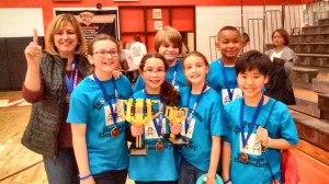 Coach Laura Minor signals "Number 1" for the 15 Percent team from Heritage Elementary School, which won the championship at the Alabama State FIRST LEGO League Tournament. (CONTRIBUTED) 