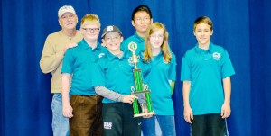 The Discovery Middle School chess team proudly shows its trophy at the Rookie Rally Chess Tournament. The team includes coach Don Maddox, from left, Charlie Makowski, Michael Guthrie, Douglas Zhang, Erin Kueck and Corbin Holland Jr. (CONTRIBUTED) 