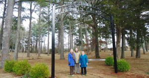 Jeanne Steadman, from left, Steve Abbott and Cindi Sanderson stand under the Old Madison Cemetery arch on Maple Street. (RECORD PHOTO/GREGG PARKER) 